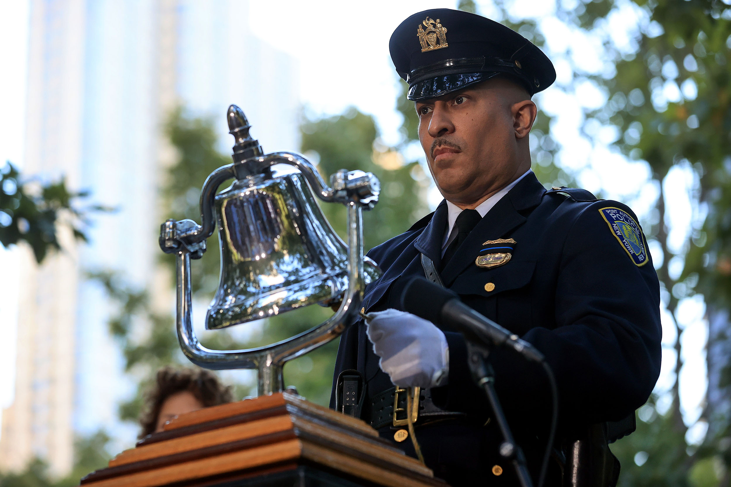 NEW YORK, NEW YORK - SEPTEMBER 11: A bell is rung during a moment of silence during the annual 9/11 Commemoration Ceremony at the National 9/11 Memorial and Museum on September 11, 2021 in New York City. During the ceremony six moments of silence were held, marking when each of the World Trade Center towers was struck and fell and the times corresponding to the attack on the Pentagon and the crash of Flight 93. The nation is marking the 20th anniversary of the terror attacks of September 11, 2001, when the terrorist group al-Qaeda flew hijacked airplanes into the World Trade Center, Shanksville, PA and the Pentagon, killing nearly 3,000 people. (Photo by Chip Somodevilla/Getty Images)