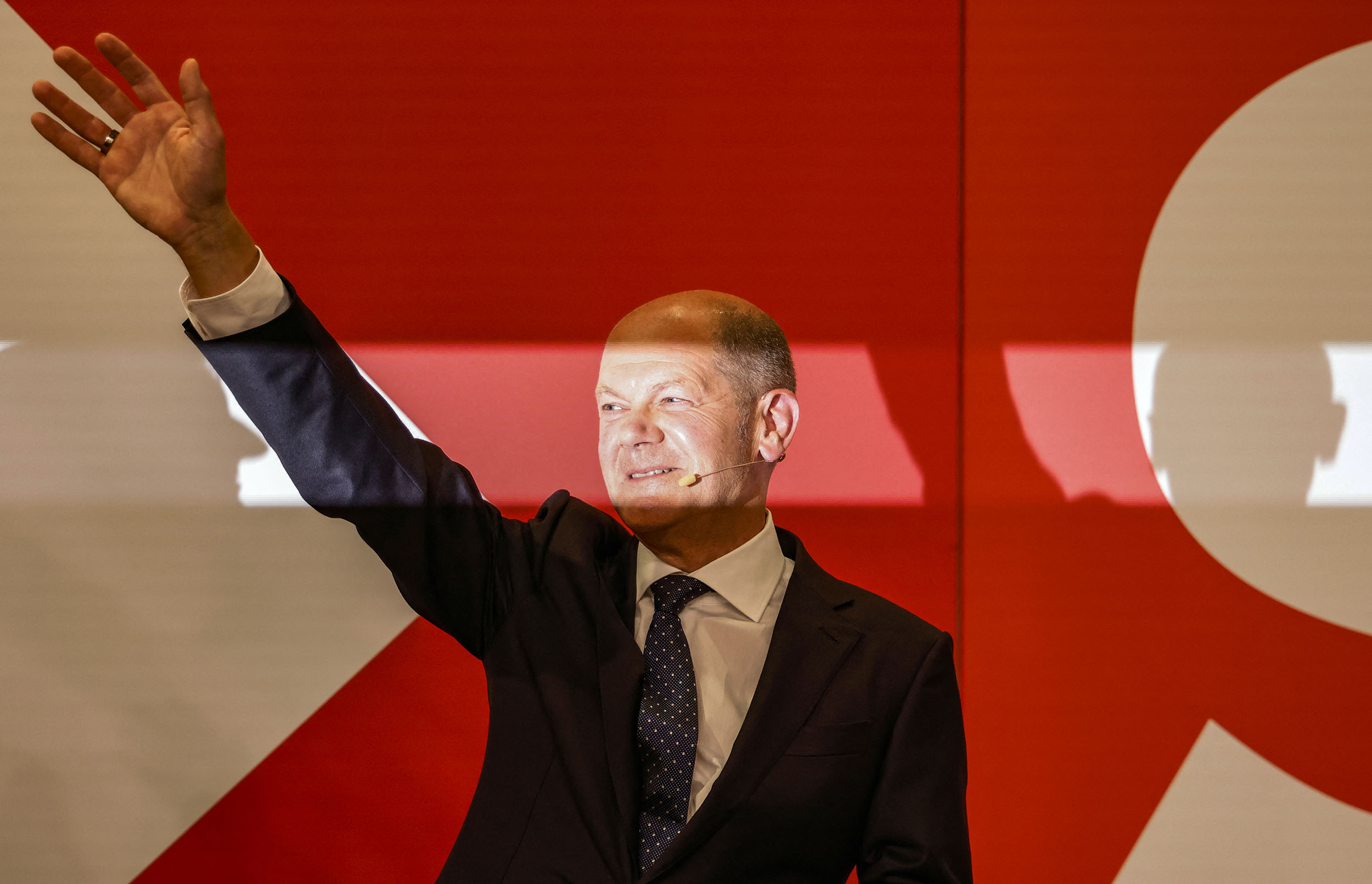 German Finance Minister, Vice-Chancellor and the Social Democrats (SPD) candidate for Chancellor Olaf Scholz waves on stage at the Social Democrats (SPD) headquarters after the estimates were broadcast in Berlin on September 26, 2021 after the German general elections. (Photo by Odd ANDERSEN / AFP)