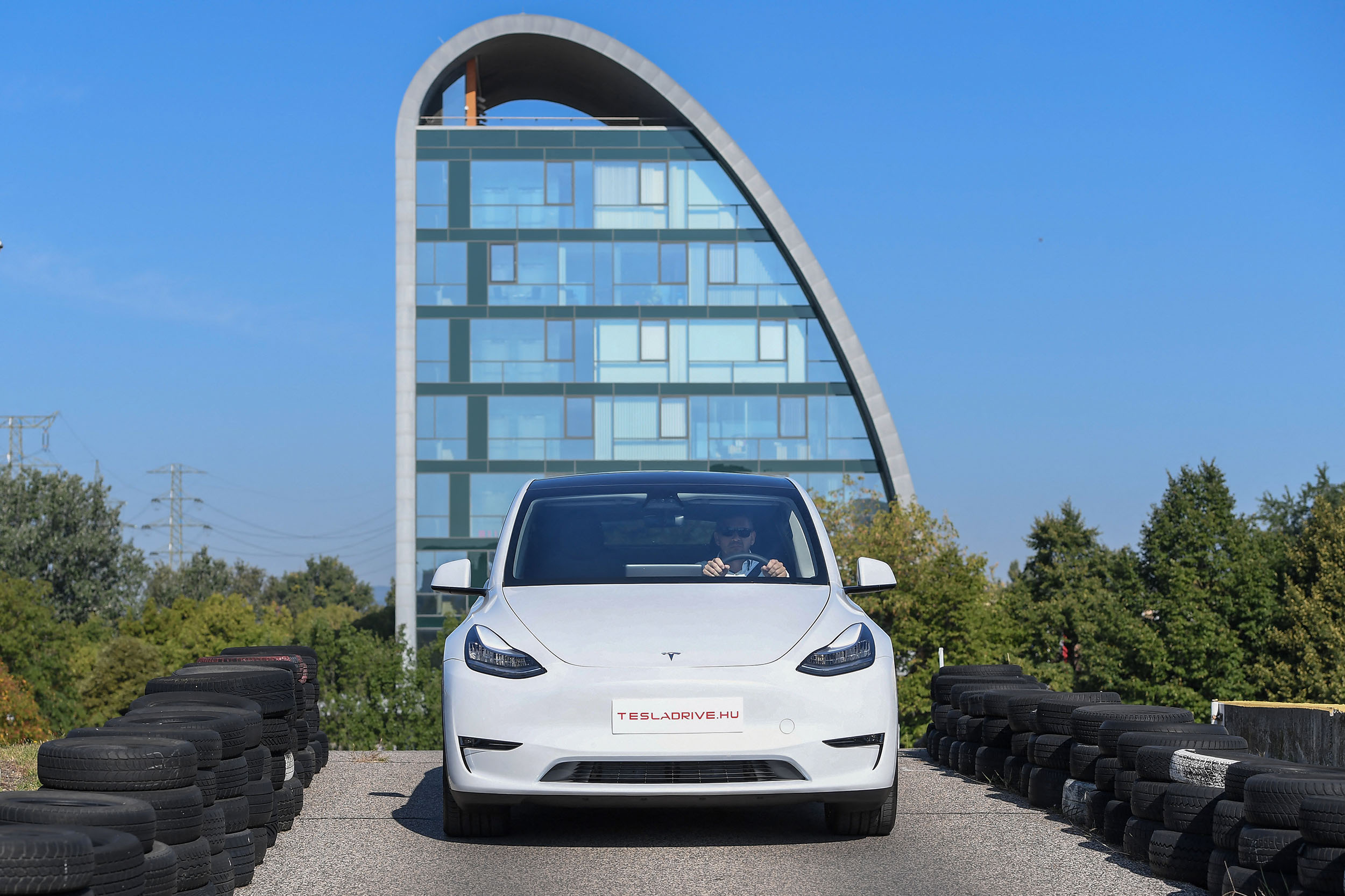 A picture taken on September 5, 2020 shows a "Tesla Model Y" car, an all-electric compact SUV by US electric car giant Tesla, during its presentation at the Automobile Club in Budapest. (Photo by ATTILA KISBENEDEK / AFP)