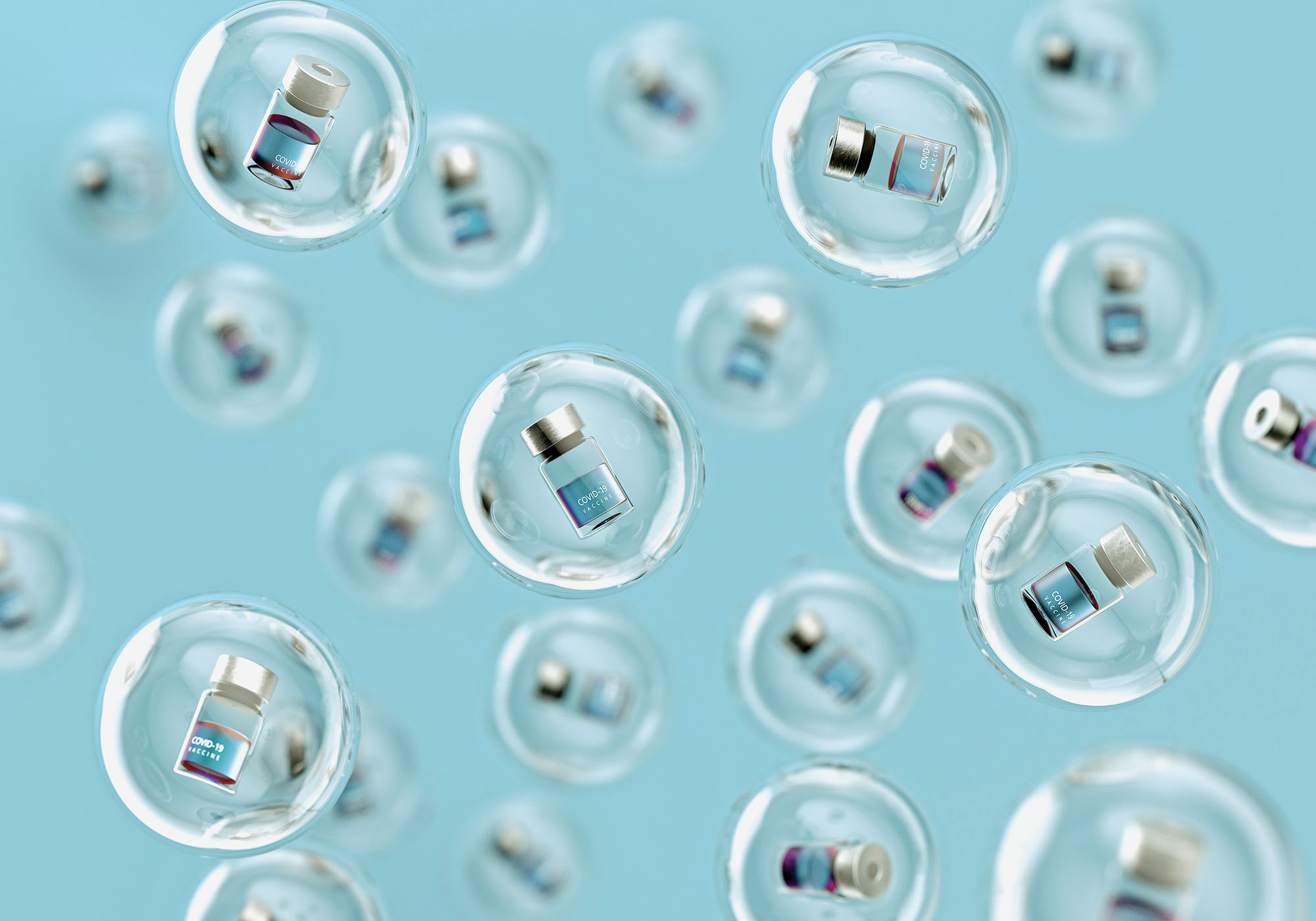 Digital generated image of COVID-19 vaccine bottles inside glass spheres levitating against light blue background.